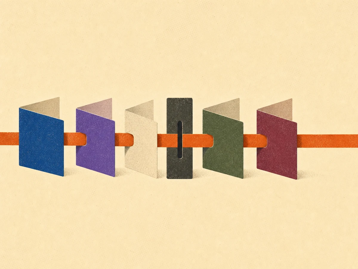 Five paper modules connected by an amber ribbon pinched through a central charcoal slot
